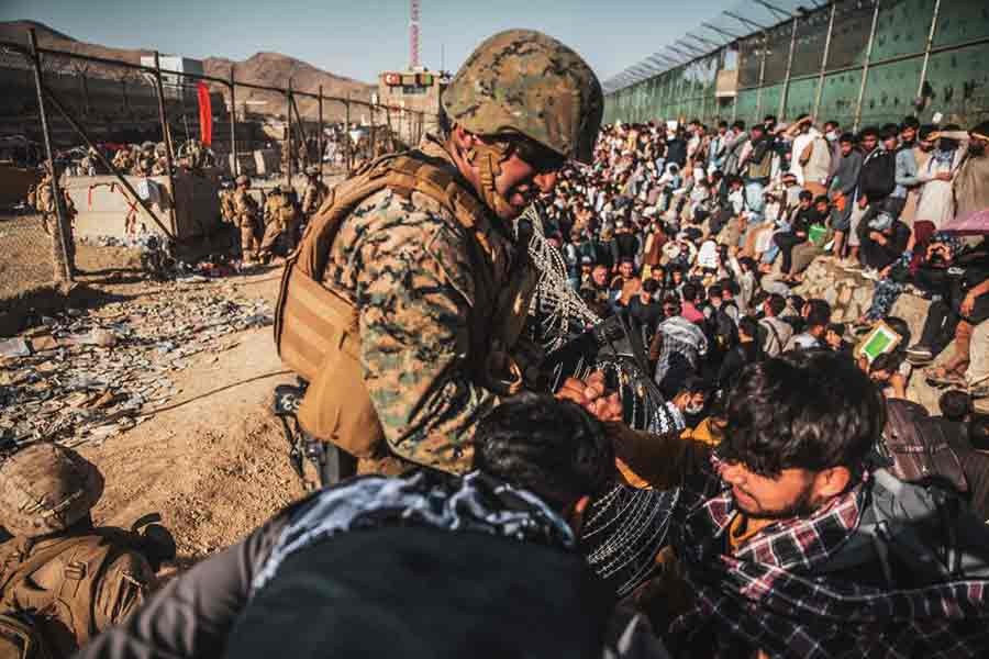 A US Marine assisting at an Evacuation Control Check Point (ECC) during an evacuation at Hamid Karzai International Airport in Kabul of Afghanistan on August 26 -Reuters file photo