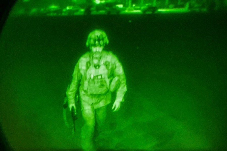 US Army Major General Chris Donahue, commander of the 82nd Airborne Division, steps on board a transport plane as what the XVIII Airborne Corps calls the last Soldier to leave Kabul, Afghanistan August 31, 2021 in a photograph using night vision optics — XVIII Airborne Corps via Reuters. (Please use this one for social streep)