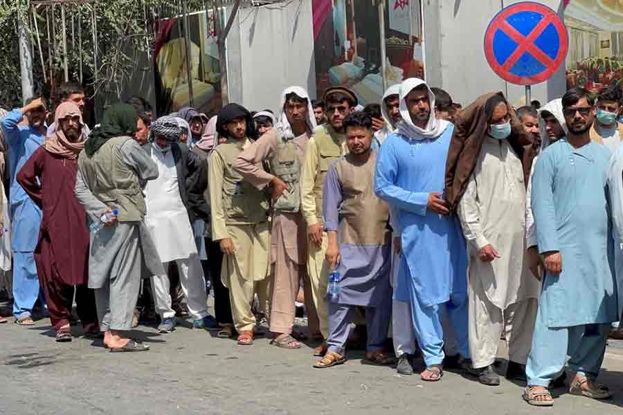 Afghans standing outside a bank in a queue to take out their money on September 1 in Kabul -Reuters photo