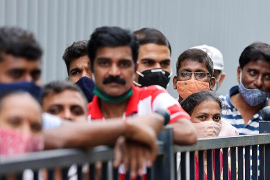 People wait in a queue to receive the vaccine against coronavirus disease (Covid-19) outside a cinema hall in Mumbai, India on August 17, 2021 — Reuters/Files