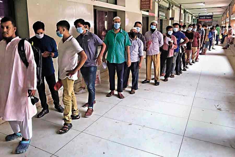 People waiting in a long queue for their turn to receive Covid jabs at Shaheed Suhrawardy Medical College and Hospital in the city on Wednesday -FE file photo