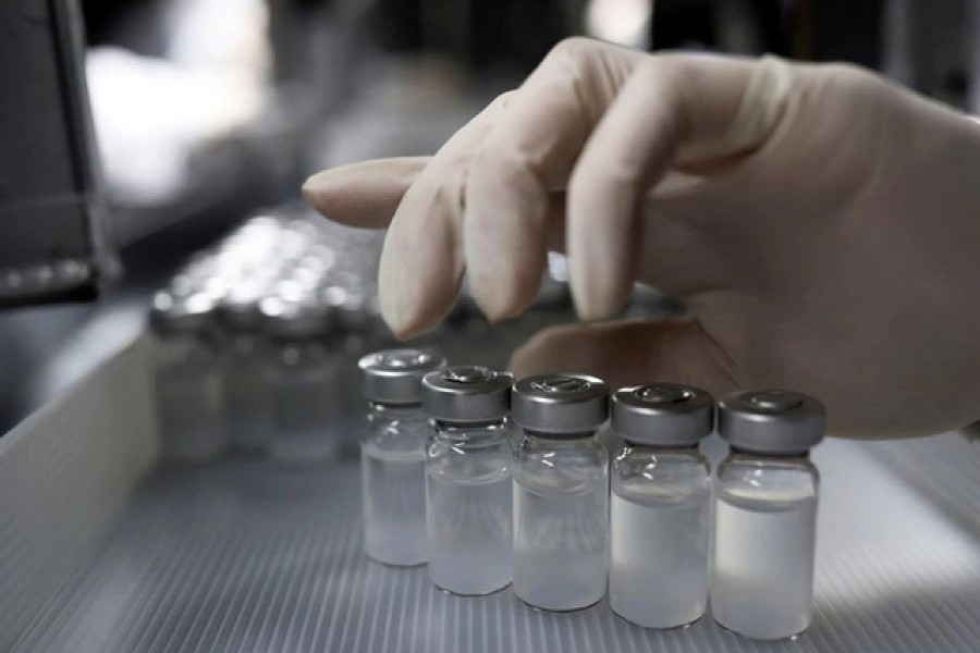 An employee handles vials containing CoronaVac, Sinovac Biotech's vaccine against the COVID-19 at Butantan biomedical center in Sao Paulo, Brazil January 12, 2021. REUTERS