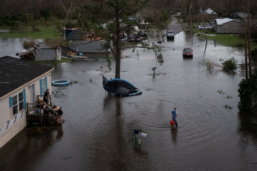 A man walks back to his home after sharing fuel with his neighbors, to use for their generator, in the aftermath of Hurricane Ida in Cut Off, Louisiana, US, August 30, 2021. REUTERS/Adrees Latif/File Photo