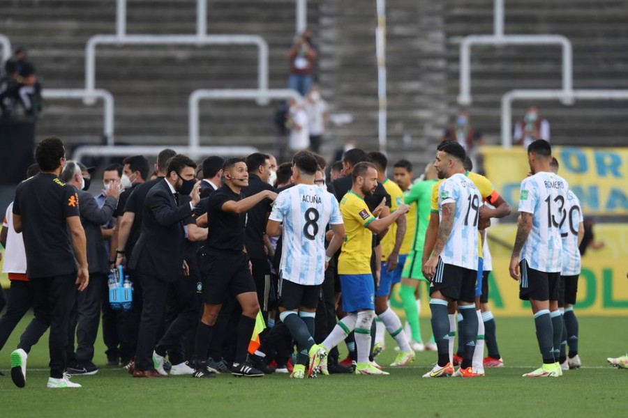 Players and officials are seen on the pitch as play is interrupted after Brazilian health officials objected to the participation of three Argentine players they say broke quarantine rules — Reuters photo