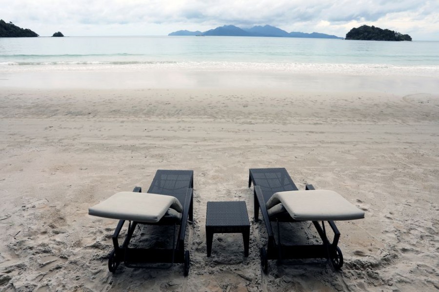 Empty chairs are seen at The Datai Langkawi resort beach, as Langkawi gets ready to open to domestic tourists from September 16, amid the coronavirus disease (COVID-19) outbreak, Malaysia September 14, 2021. REUTERS/Lim Huey Teng