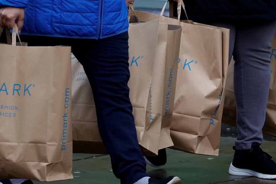 Shoppers carrying bags from Primark at the start of the Boxing Day sales amid the outbreak of the coronavirus disease (COVID-19) in Manchester of Britain on December 26 last year –Reuters file photo