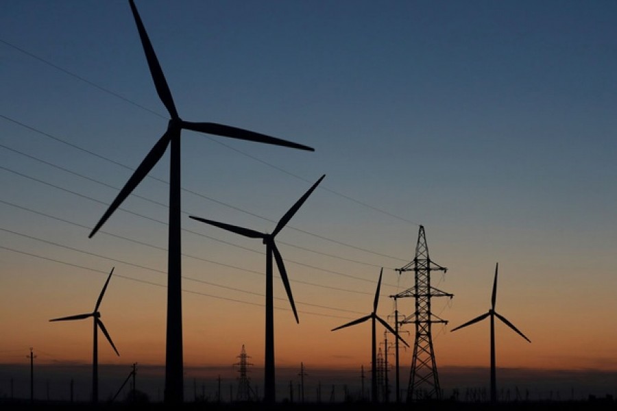 Wind turbines are pictured during sunset in Almaty Region, Kazakhstan Nov 7, 2020. REUTERS/Pavel Mikheyev