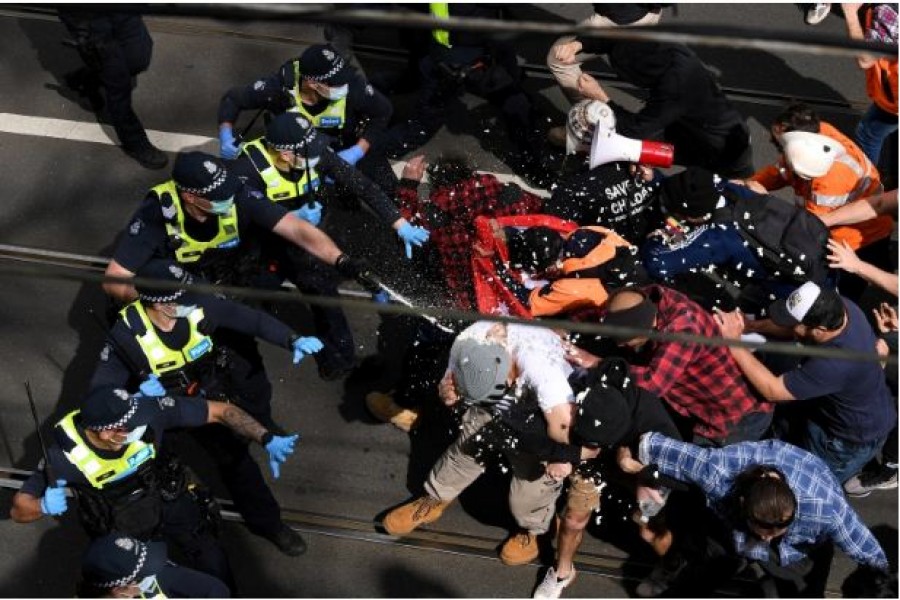 Victoria police clash with protesters during an anti-COVID lockdown demonstration in Melbourne, Australia [James Ross/AAP via Reuters]