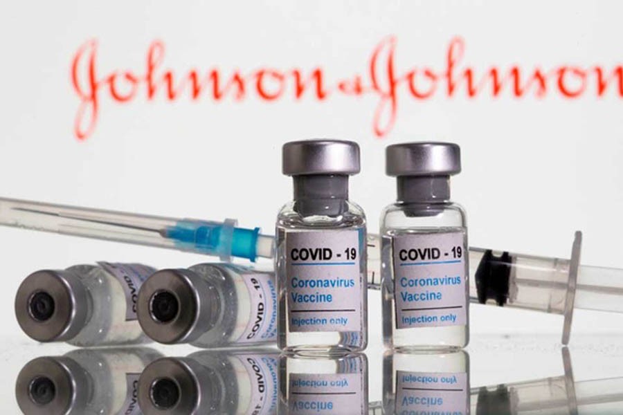 Vials labelled "COVID-19 Coronavirus Vaccine" and syringe are seen in front of the displayed Johnson&Johnson logo in this illustration taken, Feb 9, 2021. REUTERS/Dado Ruvic