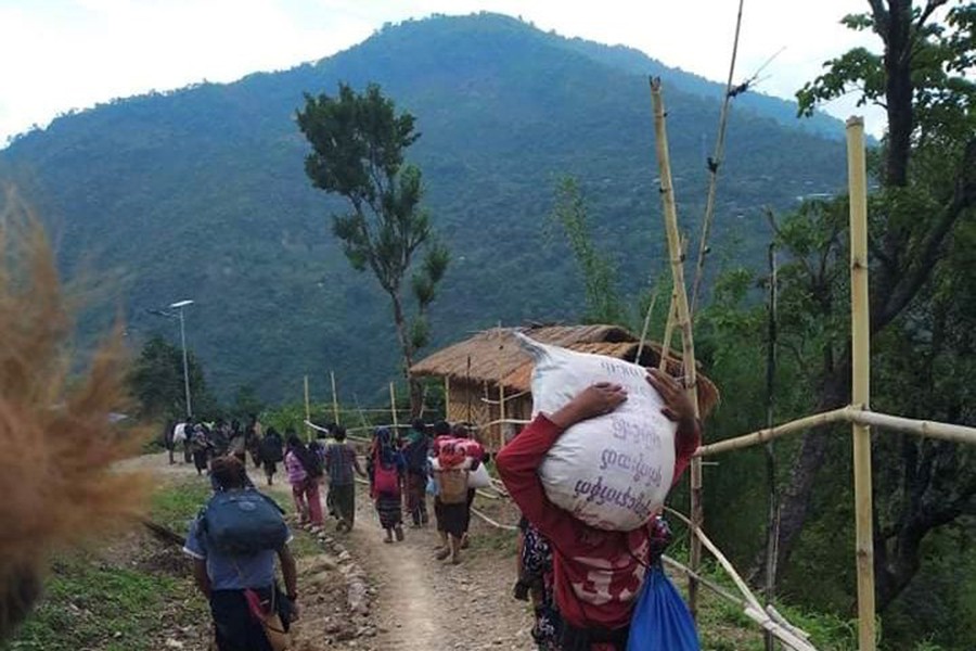 People displaced by fighting in north-western Myanmar between junta forces and anti-junta fighters walk in Chin State, Myanmar on May 31, 2021 — Reuters/Files