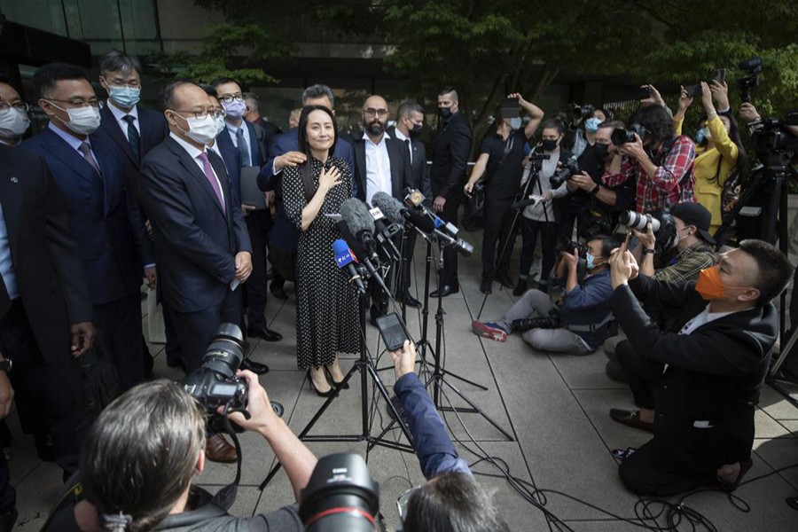 Meng Wanzhou, chief financial officer of Huawei, prepares to read a statement outside BC Supreme Court in Vancouver, British Columbia, Friday, Sept 24, 2021 — Darryl Dyck/The Canadian Press via AP