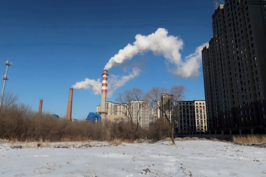 FILE PHOTO: A coal-fired heating complex is seen behind snow-covered ground in Harbin, Heilongjiang province, China November 15, 2019. REUTERS/Muyu Xu/File Photo/File Photo