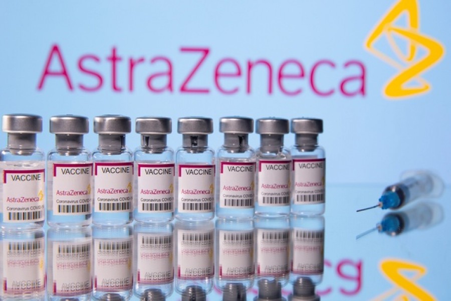 Vials labelled "Astra Zeneca Covid-19 Coronavirus Vaccine" and a syringe are seen in front of a displayed AstraZeneca logo, in this illustration photo taken March 14, 2021 -- Reuters/Files