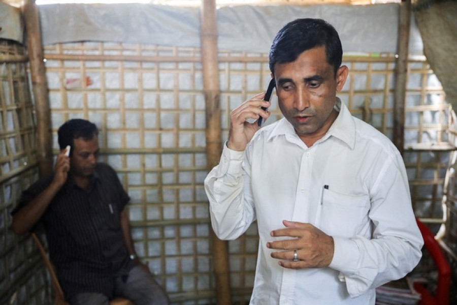 Mohib Ullah, a Rohingya Muslim leader from the Arakan Rohingya Society for Peace and Human Rights, speaks on a phone at his residence in Kutupalong refugee camp in Ukhiya, Cox’s Bazar, Bangladesh, April 21, 2018 — Reuters