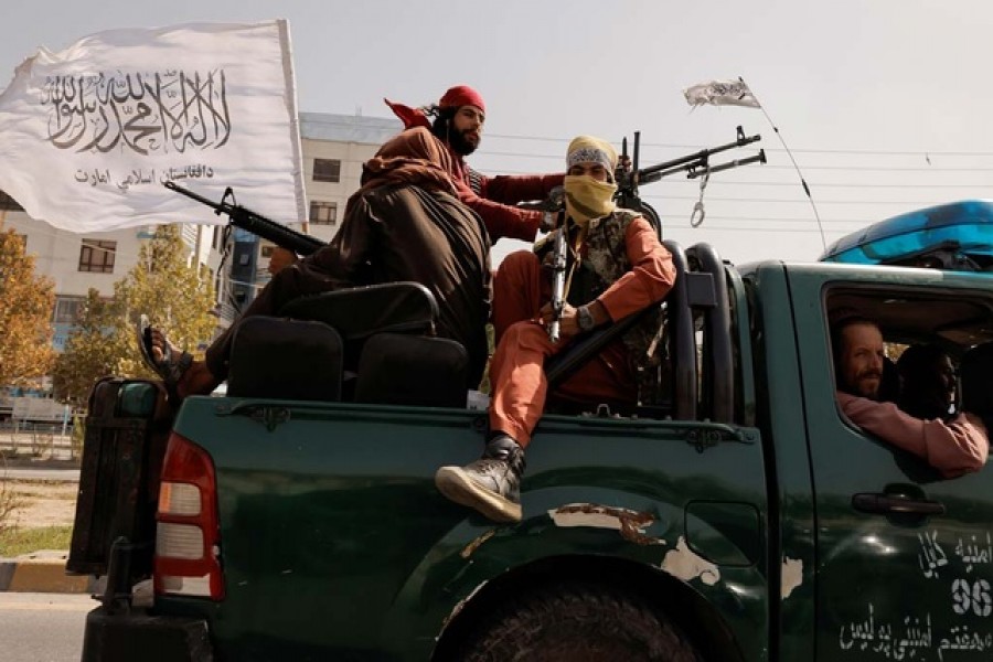 Members of Taliban forces ride on a pick-up truck mounted with a weapon in Kabul, Afghanistan, October 3, 2021. REUTERS/Jorge Silva