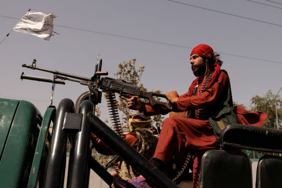 Members of Taliban forces ride on a pick-up truck mounted with a weapon in Kabul, Afghanistan, Oct 3, 2021. REUTERS/Jorge Silva