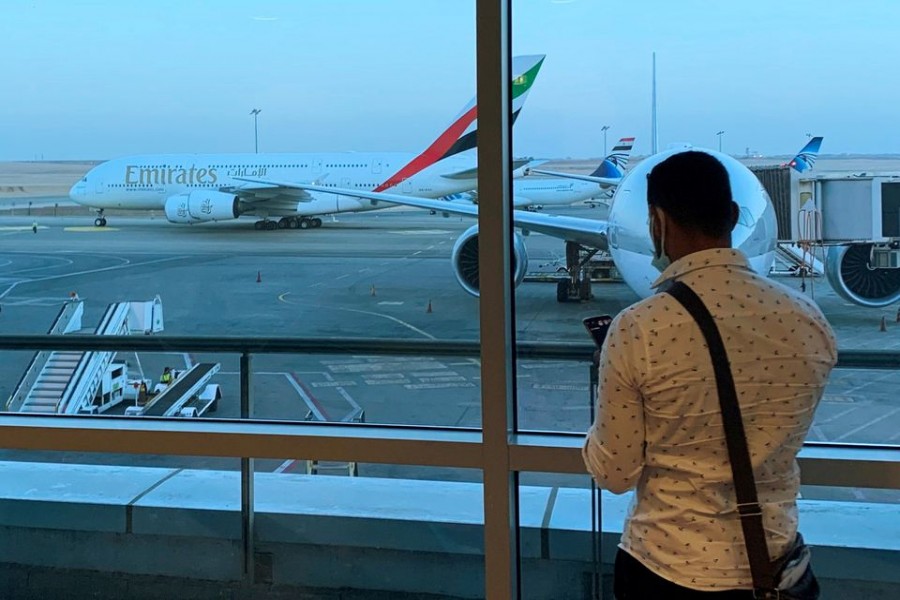 A passenger waits for his Emirates Airlines' flight departure to Dubai at Cairo's International Airport, Egypt July 20, 2021. REUTERS/Amr Abdallah Dalsh