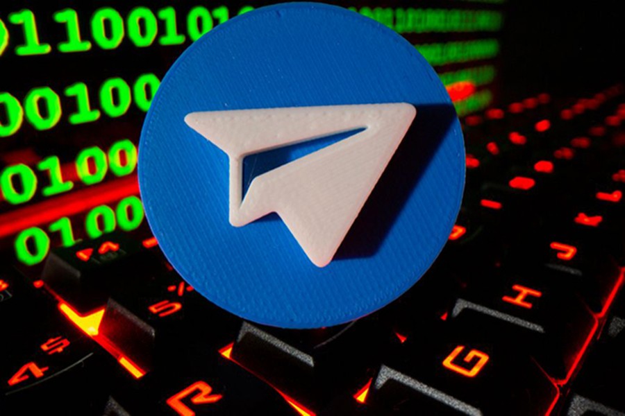 A 3D printed Telegram logo is pictured on a keyboard in front of binary code in this illustration taken on September 24, 2021 — Reuters/Files