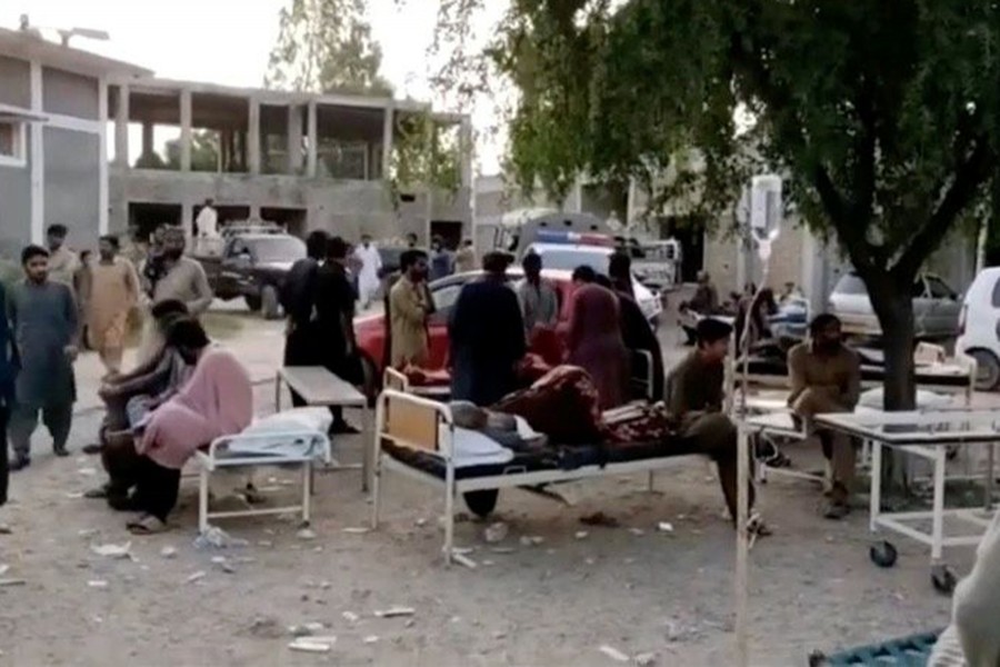 People gather outside a hospital following an earthquake in Harnai, Balochistan, Pakistan on October 7, 2021, in this still image obtained from video — Courtesy of QuettaVoice.com /Social Media via REUTERS