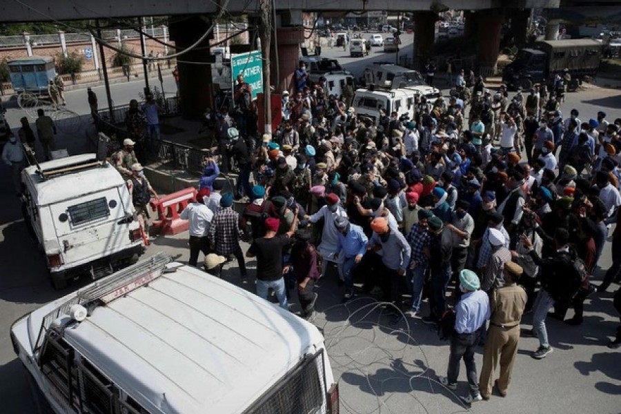 People break police cordon as they carry the body of Supinder Kour, a school teacher who was shot and killed by suspected militants on Thursday, during her funeral in Srinagar, October 8, 2021 --Reuters/Danish Ismail