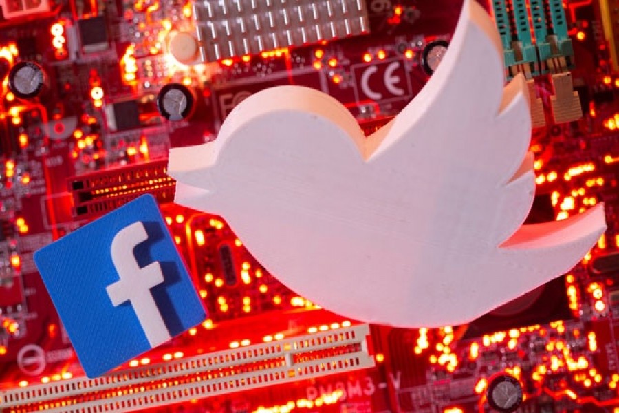 3D printed Facebook and Twitter logos are placed on a computer motherboard in this illustration taken January 21, 2021 – Reuters/Files