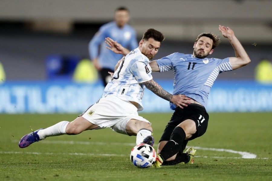 Soccer Football - World Cup - South American Qualifiers - Argentina v Uruguay - El Monumental, Buenos Aires, Argentina - October 10, 2021 Argentina's Lionel Messi in action with Uruguay's Matias Vina REUTERS/Agustin Marcarian