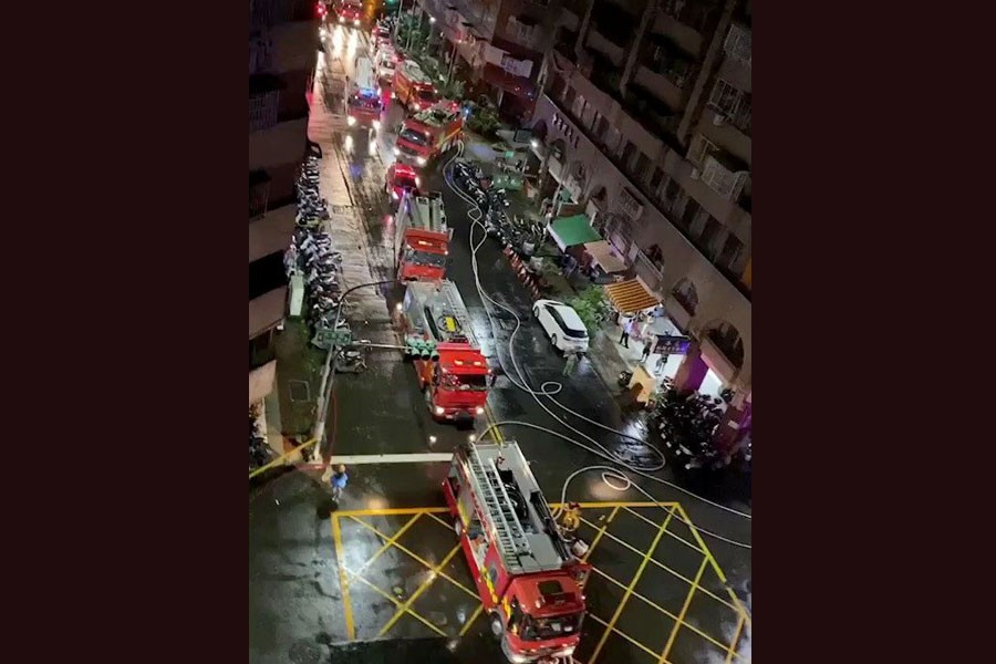 Fire trucks at the scene of a fire at Cheng Chung Cheng building in Kaohsiung, Taiwan in this still frame obtained from social media video dated early October 14, 2021. CHANG YU CHEN /via REUTERS