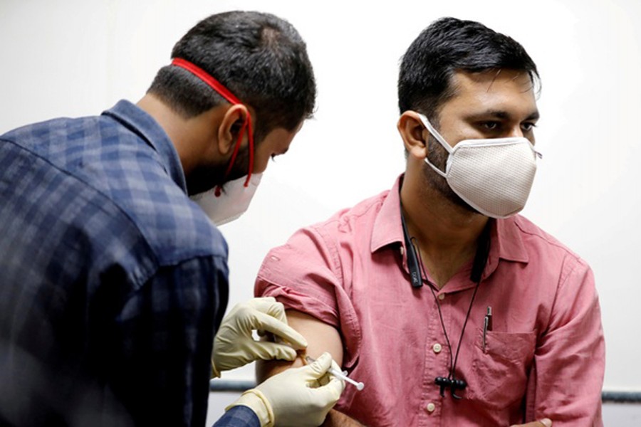 FILE PHOTO: A medic administers COVAXIN, an Indian government-backed experimental COVID-19 vaccine, to a health worker during its trials, at the Gujarat Medical Education & Research Society in Ahmedabad, India, November 26, 2020. REUTERS