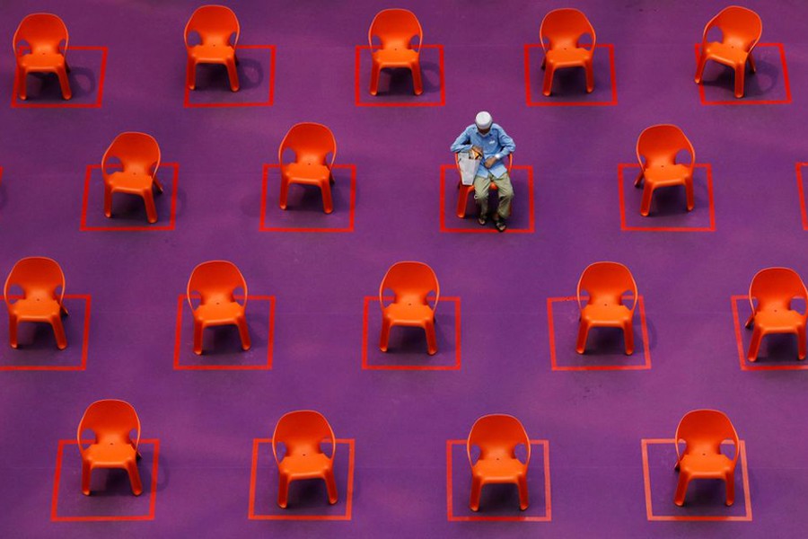 A man sits amongst empty seats at a free movie screening as restrictions on social gathering are tightened due to the surge of cases in the coronavirus disease (Covid-19) outbreak, in Singapore on September 29, 2021 — Reuters/Files