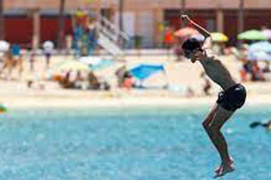 A tourist jumping into the sea on the Amadores beach, amid the outbreak of the coronavirus disease (COVID-19) in the south of the island of Gran Canaria of Spain on August 3 –Reuters file photo