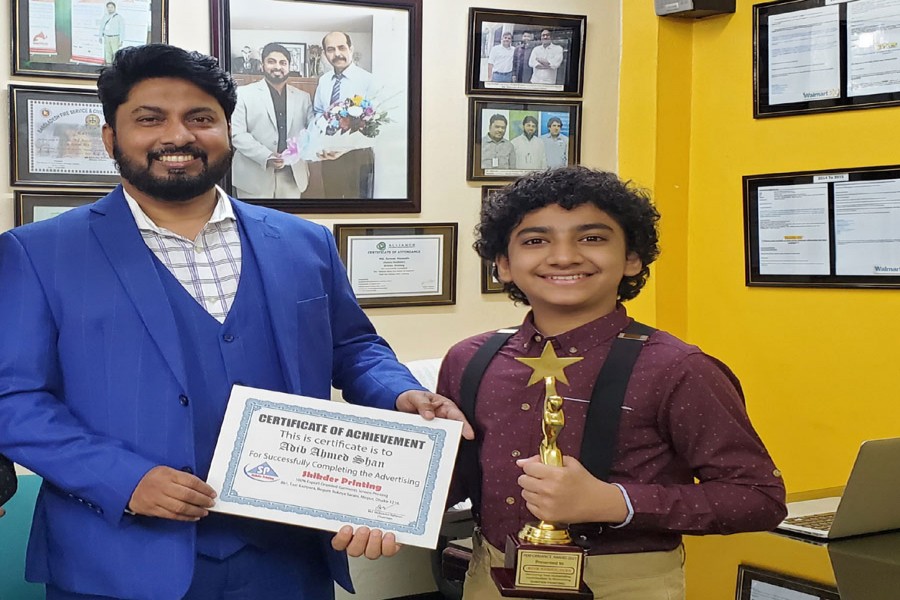 -- Chairman of Sikdar Printing Mohammad Moksedur Rahman handing over crest and certificate to  Adib Ahmed Shan on Tuesday