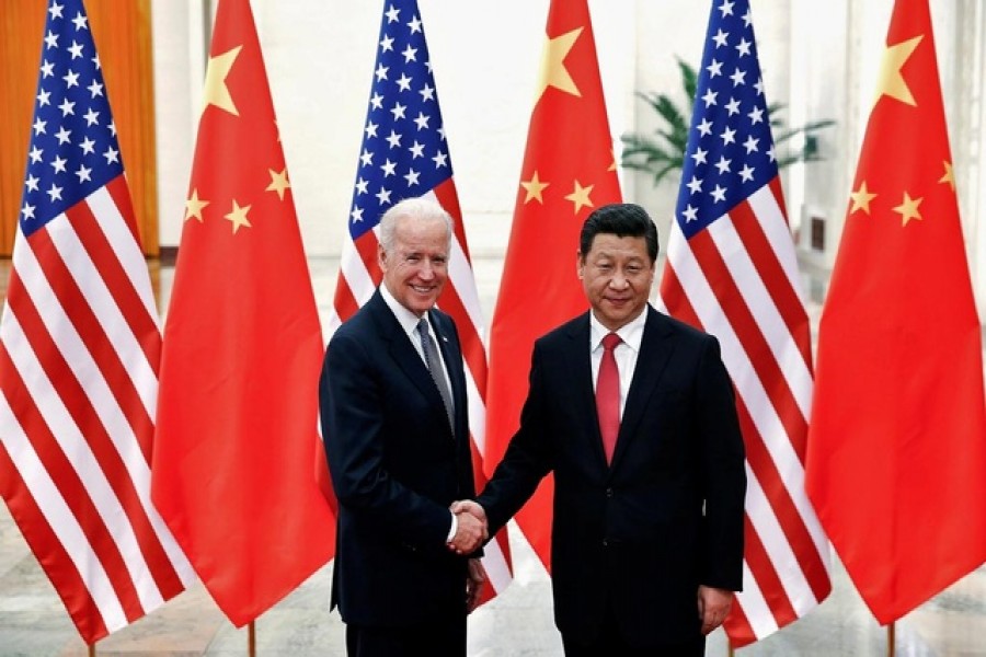 Chinese President Xi Jinping shakes hands with US Vice President Joe Biden (L) inside the Great Hall of the People in Beijing December 4, 2013 — Reuters/Files