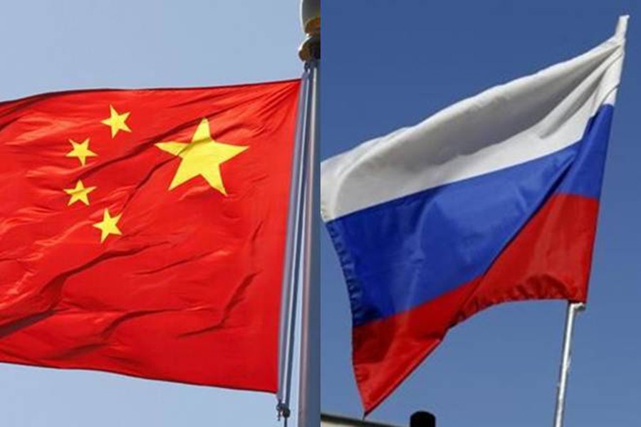 Flags of China (left) and Russia are seen in this combination photo — Collected