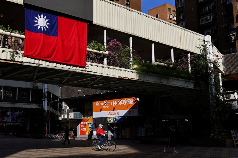 A man cycles past a Taiwan flag in Taipei, Taiwan on November 16, 2021 — Reuters/Files