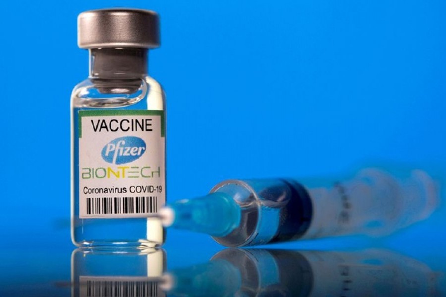 A vial labelled with the Pfizer-BioNTech coronavirus disease (COVID-19) vaccine is seen in this illustration picture taken March 19, 2021. REUTERS