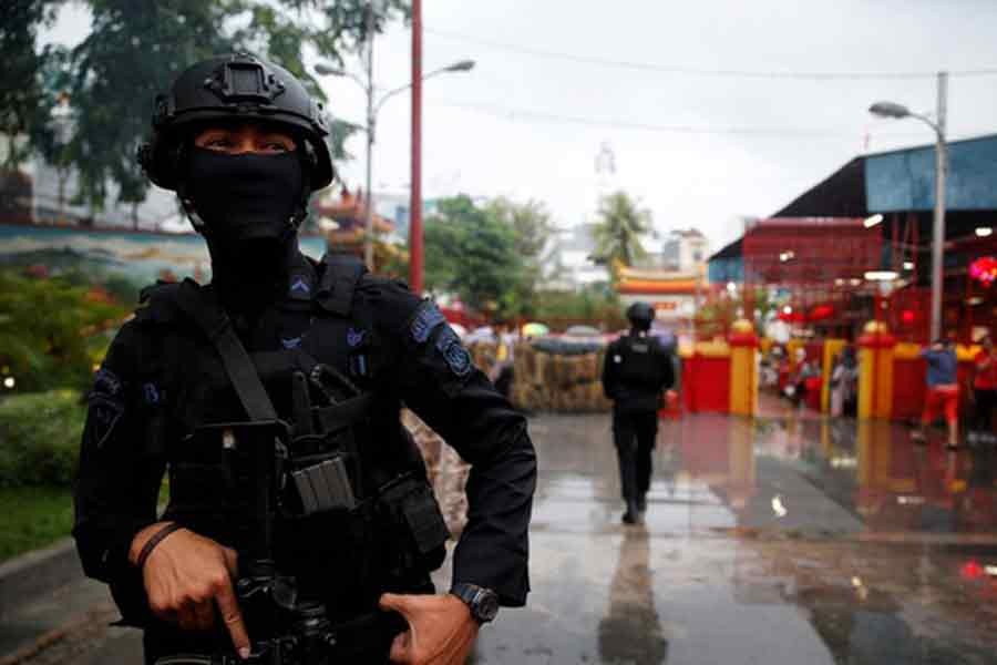 An anti-terror policeman standing guard as a security sweep is conducted during Chinese New Year celebrations at a temple in Chinatown in Jakarta on February 16 in 2018 –Reuters file photo