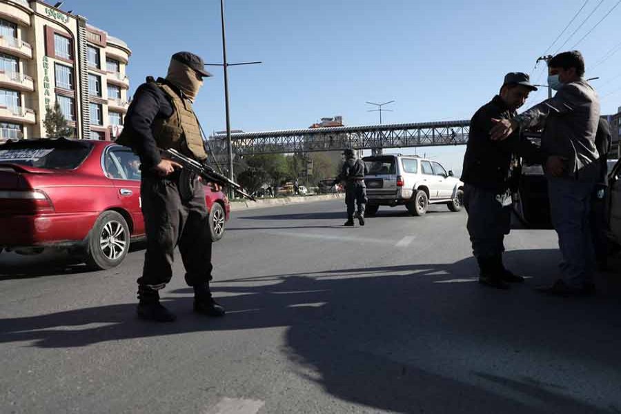 Afghan policemen keeping watch at a checkpoint in Kabul on April 19 this year -Reuters file photo