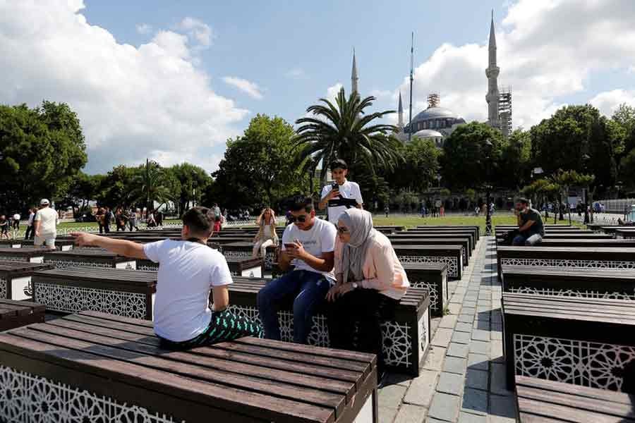 Foreign tourists sitting at Sultanahmet Square in the Old City of Istanbul on July 8 this year –Reuters file photo