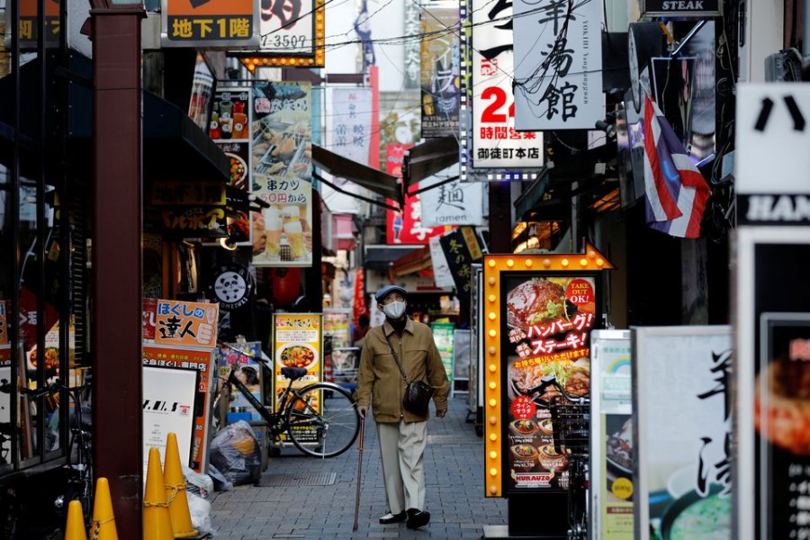 A man wearing a protective mask, amid the coronavirus disease (Covid-19) outbreak, makes his way at a restaurant district in Tokyo, Japan on December 1, 2021 — Retuers/Files