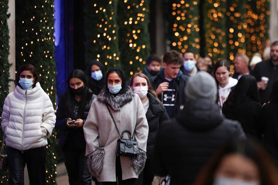 Shoppers walk along Oxford Street, amid the coronavirus disease (COVID-19) outbreak in London, Britain, December 23, 2021. REUTERS/Henry Nicholls