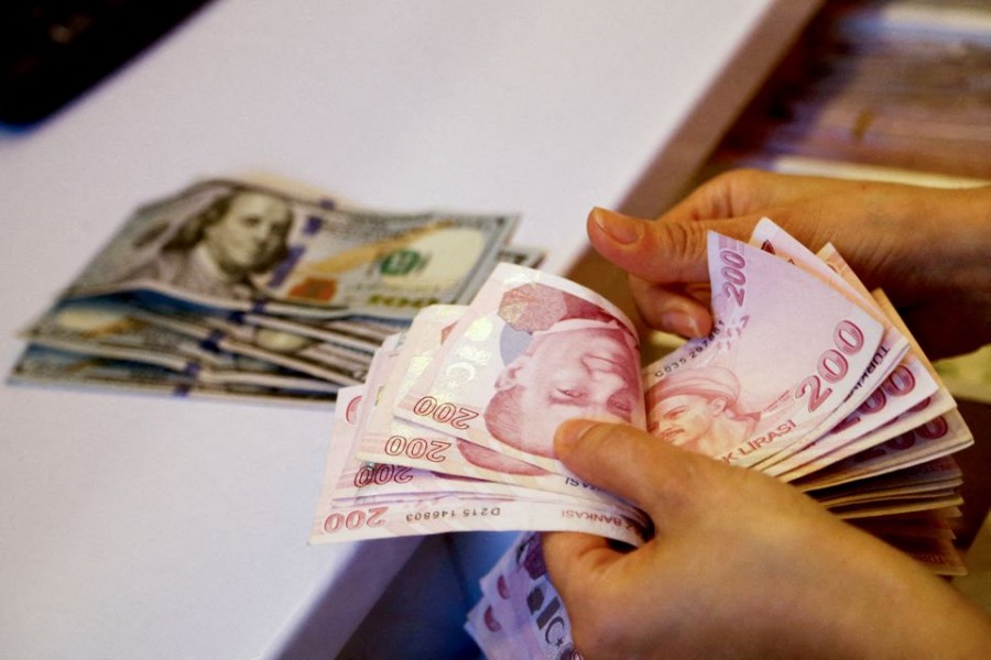 A money changer counts Turkish lira banknotes at a currency exchange office in Ankara, Turkey on September 27, 2021 — Reuters/Files