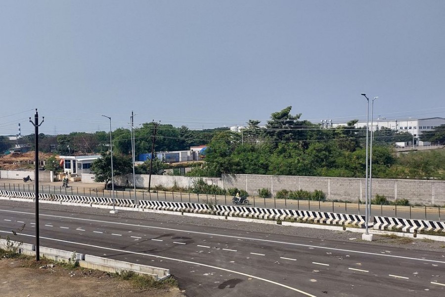 Men ride their motorbikes past a closed plant of Foxconn India unit, which makes iPhones for Apple Inc, near Chennai, India, December 21, 2021. REUTERS/Sudarshan Varadhan