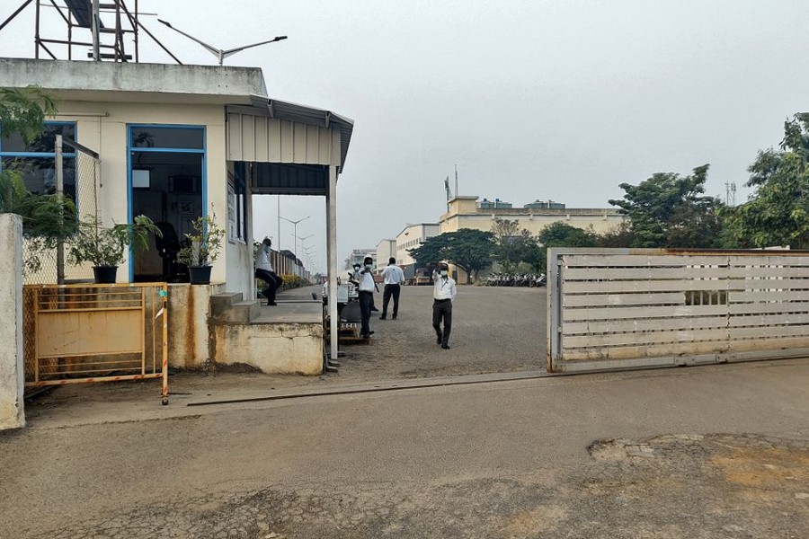 Private security guards stand at the entrance of a closed plant of Foxconn India, which makes iPhones for Apple Inc, near Chennai, India, December 22, 2021. Picture taken December 22, 2021. REUTERS/Sudarshan Varadhan