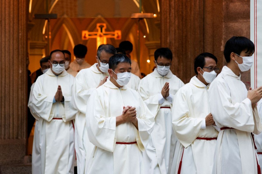 Catholic priests leave the church after the episcopal ordination of Bishop Stephen Chow in Hong Kong, China December 4, 2021. REUTERS/Tyrone Siu