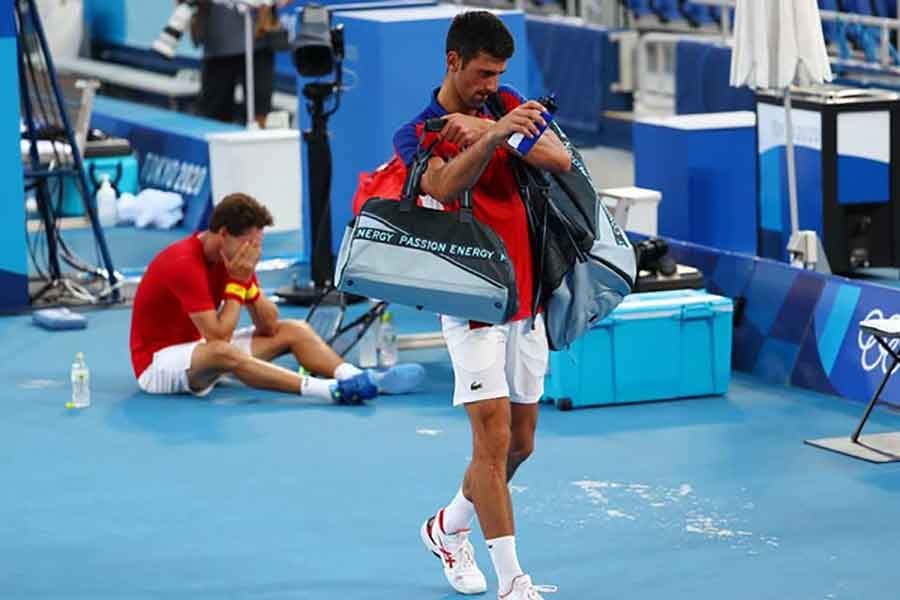 Novak Djokovic of Serbia walking off after losing his bronze medal match against Pablo Carreno of Spain on July 31 last year -Reuters file photo