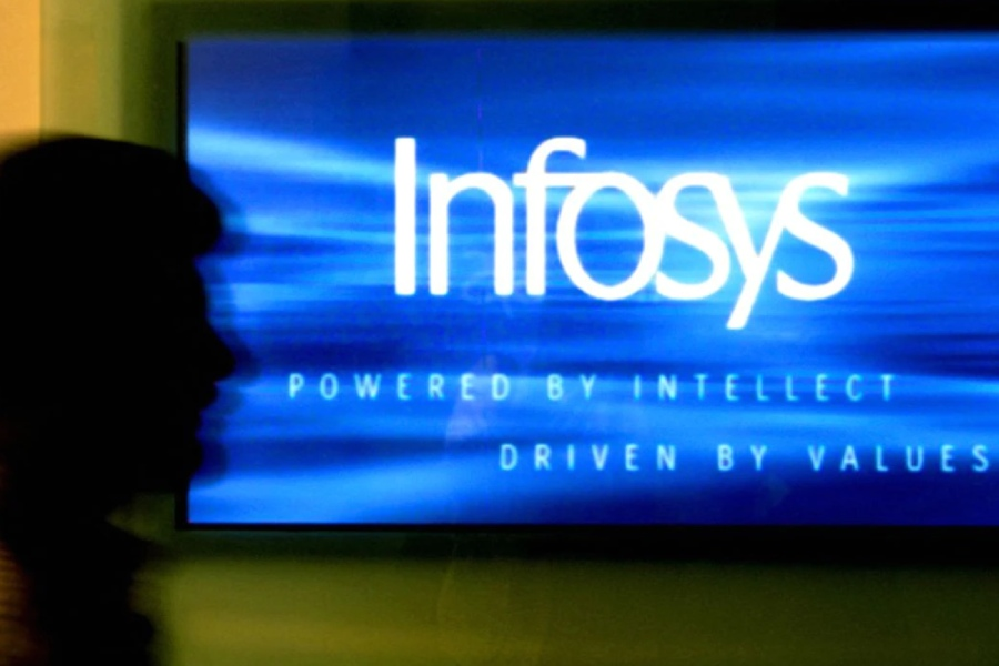 A man walks past a billboard of Infosys Technologies Ltd's office in Bangalore, capital of the southern state of Karnataka, October 10, 2003. REUTERS/Jagadeesh NV KK/FA