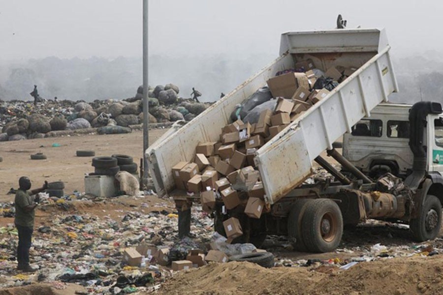 A truck offloads expired AstraZeneca coronavirus disease (COVID-19) vaccines at the Gosa dump site in Abuja, Nigeria, December 22, 2021. REUTERS/Afolabi Sotunde