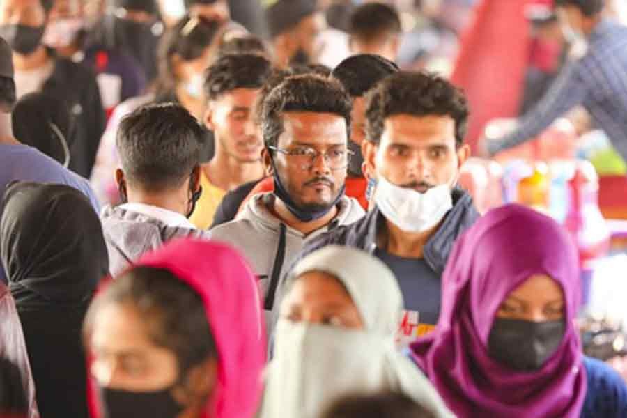 Some people are not wearing masks amid crowds defying government orders in the New Market area of Dhaka on Wednesday despite a surge in coronavirus infections. Photo: bdnews24.com