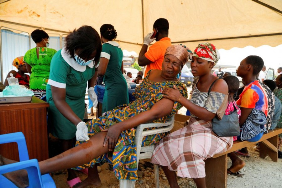 Nancy Nyarko, 51, a street vendor, receives medical attention for wounds suffered when a vehicle carrying mining explosives detonated along a road in Apiate, Bogoso, Ghana. January 22, 2022. REUTERS/Francis Kokoroko