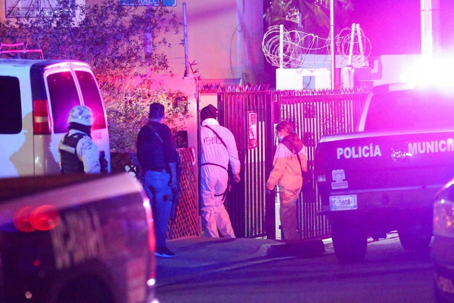 Members of a forensic team walk near at the crime scene where a Mexican journalist Lourdes Maldonado was shot dead outside her home in the northern border city of Tijuana, Mexico, January 23, 2022. REUTERS/Jorge Duenes